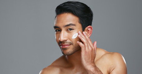Image showing Face, cream and man with skincare, cosmetics and dermatology on a grey studio background. Portrait, person and model with creme, beauty or luxury treatment with grooming, shine or glow with aesthetic