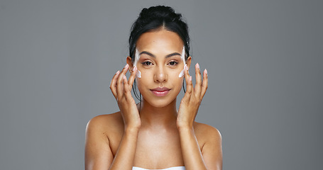 Image showing Face, skincare and happy woman apply cream in studio isolated on gray background mockup. Portrait, natural beauty and model with moisturizer, cosmetics and product for wellness, dermatology or health