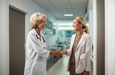 Image showing A compassionate doctor shares a handshake with her patient, signifying a successful and trustful completion of hospital treatment