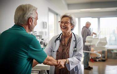 Image showing A compassionate female doctor shares a handshake with an elderly man, symbolizing gratitude and successful completion of hospital treatment