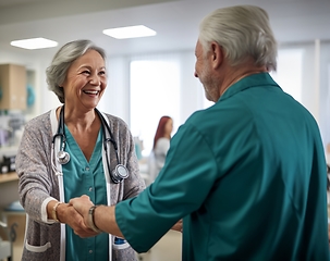 Image showing A compassionate female doctor shares a handshake with an elderly man, symbolizing gratitude and successful completion of hospital treatment