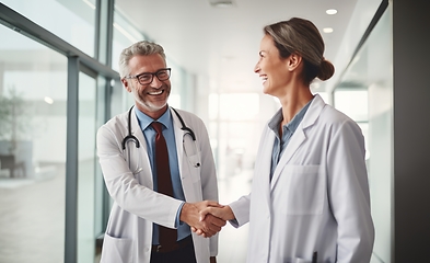 Image showing In a modern hospital corridor, doctors exchange handshakes, reflecting professional unity and collaborative teamwork