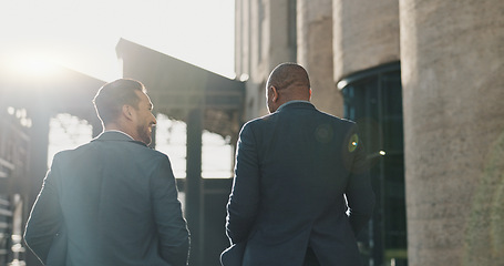 Image showing Business, men and travel in city with discussion for morning commute, partnership and rear view with lens flare. Employees, people and talking for collaboration and networking outdoor in urban town