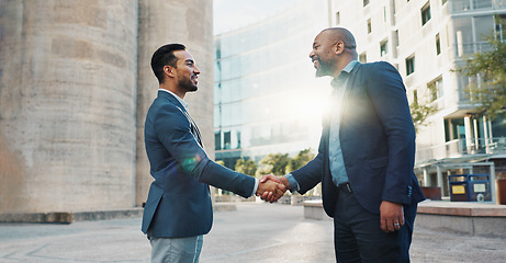 Image showing Business men, friends and shaking hands in city for introduction, hello or meeting with respect, smile or welcome. People, professional staff and happy for handshake, deal or agreement for onboarding