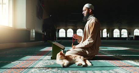 Image showing Quran, islamic and man with faith in a mosque for praying, peace and spiritual care in holy religion for Allah. Reading book, Ramadan and Muslim person with beads, hope or grastitude to worship God