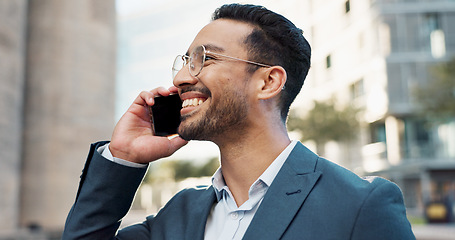 Image showing Asian businessman, phone call or happy with talking in city, office buildings or view of workplace in professional career. Young lawyer, chat or smartphone in connection or discussion in cbd in town