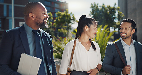 Image showing Business people, walking and travel in city with talking on morning commute, partnership and happy. Employees, men and woman with conversation, collaboration and networking outdoor in urban town