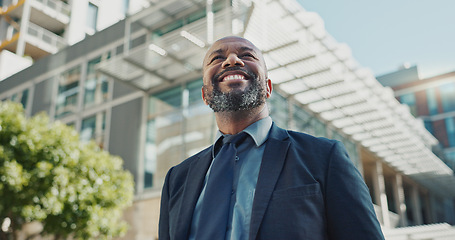 Image showing Mature businessman, city and happy by office buildings in morning, view and travel to workplace in accounting career. African lawyer, positive and professional for ambition and working in town in cbd