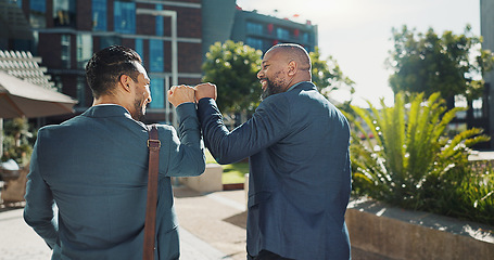 Image showing Business people, fist bump and greeting outdoor, deal and thank you for partnership in the city. Back, happy team and hand gesture for agreement, collaboration and men walking together in urban town