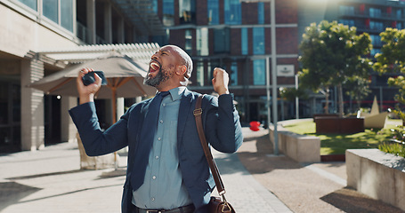 Image showing Business, celebration and senior man with phone in city street for news, success and winner fist victory. Smartphone, app and African male entrepreneur outdoor with competition prize, reward or bonus