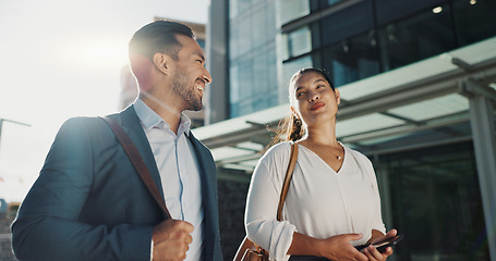 Image showing Business people, walking and travel in city with discussion on morning commute, partnership and happy. Employees, man and woman with conversation, collaboration and networking outdoor in urban town