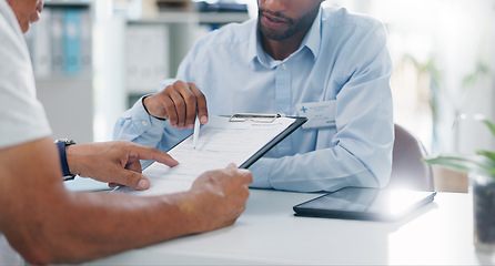 Image showing Man, doctor and hands with form in consultation for signature, application or health insurance at hospital. Closeup of person or medical employee explaining document or paperwork to patient at clinic