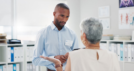 Image showing Black man, healthcare and tablet with patient for consultation, checkup or results at clinic. Medical professional, technology and office for schedule, diagnosis or heart disease of elderly woman