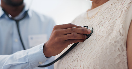 Image showing Hand, chest and stethoscope, doctor and patient for healthcare, cardiology and listening to heart at clinic. Medical exam for diagnosis, monitor heartbeat and people in consultation with health