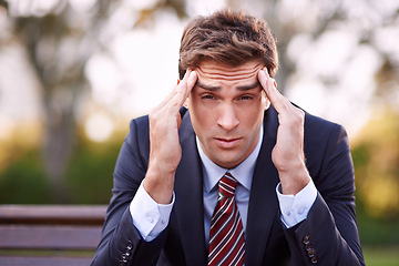 Image showing Portrait, stress and businessman with headache at park outdoor, financial crisis or frustrated at challenge. Face, migraine and professional massage temple, pain and anxiety for mistake of lawyer