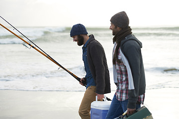 Image showing Nature, fishing and men walking on beach together with cooler, tackle box and holiday conversation. Ocean, fisherman and friends with rods, bait and tools at waves on winter morning vacation at sea.