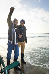 Image showing Happy, surprise and people with fish at water with pride for catch of tuna on pier at sunset. Fishing, friends and fisherman smile with shock at success in nature at sea on holiday or vacation