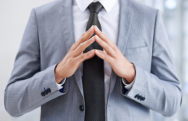 Image showing Hands in front of chest, business and man with confidence, closeup and suspicious in workplace. Person, employee or consultant in suit, gesture or deception with fraud or idea with feedback or review