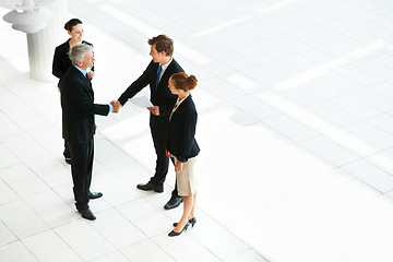 Image showing Business people, shaking hands and thank you for welcome in introduction, hello and opportunity. Partnership, onboarding and coworkers in agreement, top view and promotion in office or collaboration