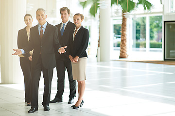 Image showing Leader, portrait and business people in a lobby, collaboration and smile with property management and cooperation. Group, manager or employees with teamwork or partnership with real estate agency