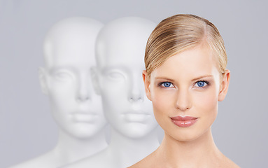 Image showing Woman, mannequins and face for identity, beauty and individuality on studio background. Person, skincare and dummy with portrait for creativity and cosmetics or unique ideas for satisfaction and skin