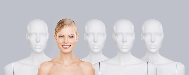 Image showing Woman, mannequins and smile for identity, beauty and individuality on studio background. Person, skincare and dummy with face for creativity and cosmetics or unique ideas for satisfaction and skin