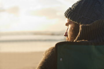 Image showing Face, thinking and man at beach at sunset to relax on holiday or vacation for travel in summer. Nature, sunshine and view with young person on coast by sea or ocean for peace and quiet from back