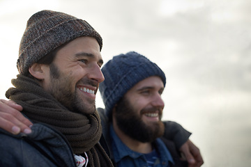 Image showing Happy, men and friends hug at a beach for bonding, holiday and adventure in winter together. Travel, smile and people embrace in nature for ocean vacation, journey or fun journey in South Africa