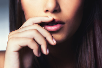 Image showing Beauty, hand and closeup of woman lips in studio for facial makeup routine with gloss. Cosmetic, beautiful and zoom of female person touching mouth for cosmetology treatment by gray background.