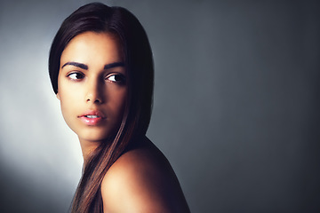 Image showing Face, hair care and beauty of woman, natural and shine in salon isolated on a grey studio background mockup. Glow, hairstyle and serious young model in cosmetics, hairdresser or thinking of skincare