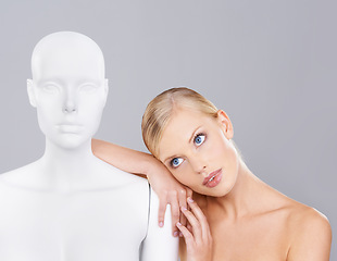 Image showing Woman, beauty and relax with mannequin, thinking and unique skincare with wellness on white background. Inspiration, natural cosmetics and dermatology with individuality, robot or dummy in studio