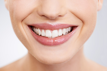Image showing Beauty, mouth and teeth with woman closeup in studio on gray background for dental care or oral hygiene. Skincare, smile and orthodontics with happy young model at spa or dentist for natural wellness