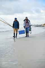 Image showing Adventure, fishing and men walking on beach together with cooler, tackle box and holiday bonding. Ocean, fisherman and friends with rods, bait and tools at waves on winter morning vacation at sea.