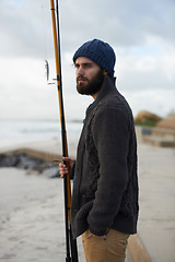 Image showing Fishing, thinking and man at a beach for water hobby, recreation or stress relief in nature. Rod, waiting and male fisherman at the ocean for travel, journey or fish sports adventure in Cape Town