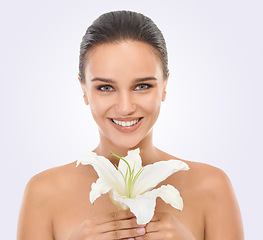 Image showing Cosmetic, floral and portrait of woman in studio with glamour, glow and natural face routine. Beauty, confident and young female person with flower plant for facial cosmetology by white background.