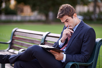 Image showing Thinking, business man and notebook at park bench for opportunity, dream or vision for remote work. Journal, idea or consultant outdoor with decision, inspiration and serious employee planning future