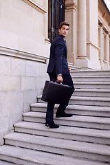 Image showing Business, briefcase and man walking on stairs outside law firm in city with evening commute, sidewalk and court building. Businessman, lawyer or attorney on outdoor steps with bag for urban travel.
