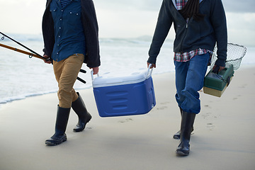 Image showing Fishing, walking and men with cooler on beach together with tackle box, water and holiday. Ocean, fisherman and feet of friends with rods, bait and tools at waves on winter morning vacation at sea.