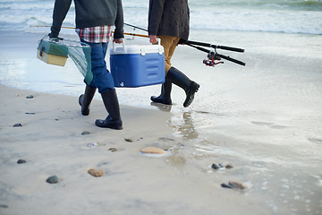 Image showing Closeup, walking and beach with fishermen, cooler box and activity with equipment or weekend break. People, ocean or friends with tools for hobby or early overcast morning with waves, sand or seaside