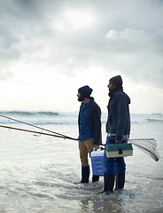 Image showing Fisherman, friends and gear on beach for fishing in the morning by sea with overcast, equipment and sky. Friendship, men and net with bonding, travel or rod by water for hobby, holiday or activity