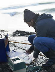 Image showing Cold, gear and beach with fisherman, cooler box and hobby with equipment and weekend break. Person, ocean and guy with tools for activity and early morning with waves, shore and seaside with vacation