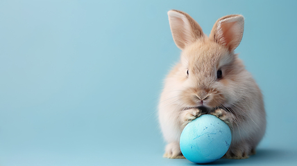 Image showing Rabbit with blue egg on blue background, happy Easter