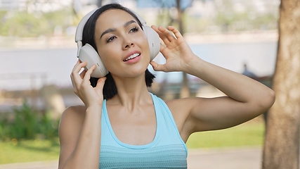 Image showing Active Woman Exercising in the Park Listening to Music