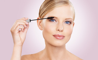 Image showing Beauty, mascara and portrait of girl in studio with confidence, makeup for lashes or facial glow. Glamour, cosmetics and face of woman on pink background with healthy skin shine, brush and wellness.