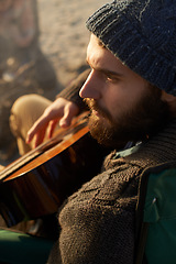 Image showing Face, beach and man playing guitar from above to relax on holiday or vacation for travel in summer. Nature, music or thinking and young hipster person with instrument on sand by ocean or sea