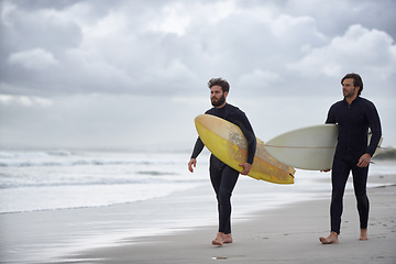 Image showing Man, friends and surfer at beach for exercise, sport or waves on sandy shore in outdoor fitness. Male person or young people with surfboard for surfing or hobby on ocean coast, sea or water in nature