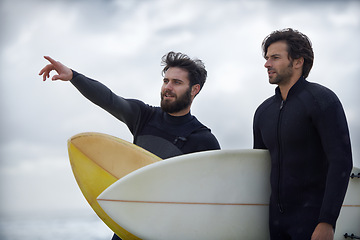 Image showing Man, friends and surfer pointing on beach for fitness, sport or waves on shore in outdoor exercise. Young male person or people with surfboard for surfing challenge or hobby on ocean coast in nature