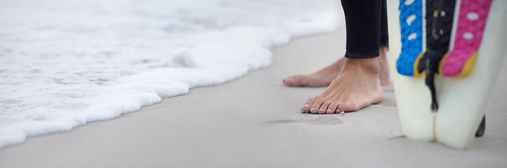 Image showing Feet, shore and surfer on beach for sports, athlete and board for outdoor adventure or ocean waves. Person, legs and closeup of nature for fitness, sea and traveling to water on holiday or vacation