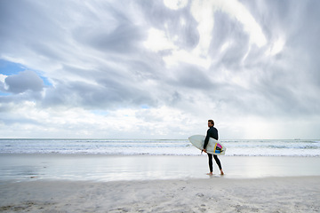 Image showing Surfboard, ocean and man on beach for surfing on vacation, holiday and weekend for wellness. Travel mockup, fitness and person for water sports, hobby and exercise for adventure and training in sea