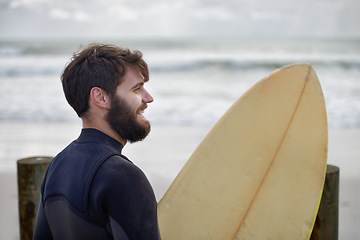 Image showing Man, surfboard and exercise at beach on vacation, weekend and sports for fitness in water. Happy male person, hobby and island for ocean waves, wetsuit and traveling on holiday or getaway for peace